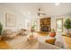 Bright living room featuring a stone fireplace, hardwood floors, and neutral decor with access to the screened porch at 601 Wofford Rd, Durham, NC 27707