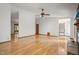 Open living room featuring hardwood floors, a ceiling fan, and access to other rooms in the house at 601 Wofford Rd, Durham, NC 27707