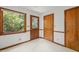 Mud Room with an exterior door, a window looking out into the yard, and wood trim at 601 Wofford Rd, Durham, NC 27707