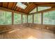 Enclosed back porch featuring skylights, wood paneling, and multiple windows offering natural light at 601 Wofford Rd, Durham, NC 27707