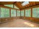 Sunroom featuring wood paneling, skylights, and views of the surrounding nature at 601 Wofford Rd, Durham, NC 27707