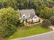 An aerial view of a house with a well-manicured lawn, mature trees, and attractive landscaping at 602 Preston Village Way, Cary, NC 27519