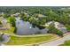 Aerial view of community featuring a lake, pool, clubhouse, and surrounding homes at 602 Preston Village Way, Cary, NC 27519
