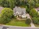 Overhead view of a home in a park-like setting with mature trees, manicured lawn, and a circular driveway at 602 Preston Village Way, Cary, NC 27519
