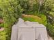 High-angle view shows the roof of a two-story home surrounded by lush greenery and mature trees at 602 Preston Village Way, Cary, NC 27519
