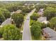 Aerial view of a neighborhood with tree-lined streets and well-maintained homes at 602 Preston Village Way, Cary, NC 27519