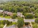 An aerial shot of a beautiful house with manicured lawns, mature trees, and a neighborhood setting at 602 Preston Village Way, Cary, NC 27519