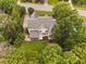 Beautiful aerial view of a two-story home featuring lush landscaping, a grey roof, and a charming front porch at 602 Preston Village Way, Cary, NC 27519