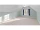 Brightly lit attic room features vaulted ceilings, neutral carpet and a window at 602 Preston Village Way, Cary, NC 27519
