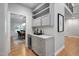 Wet bar area with gray cabinets, granite countertops, and wine storage refrigerator at 602 Preston Village Way, Cary, NC 27519