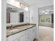 Bright bathroom boasts double sinks with granite countertop and modern fixtures at 602 Preston Village Way, Cary, NC 27519