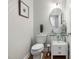 Stylish powder room features a modern glass sink, patterned wallpaper, and elegant fixtures at 602 Preston Village Way, Cary, NC 27519