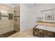 Bathroom featuring tiled walk-in shower, soaking tub, and neutral color palette at 602 Preston Village Way, Cary, NC 27519