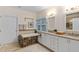 Elegant bathroom featuring a soaking tub with decorative tile surround and double vanity sinks at 602 Preston Village Way, Cary, NC 27519