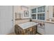 Bathroom with soaking tub and decorative tiled surround, complemented by a sunny window at 602 Preston Village Way, Cary, NC 27519