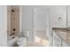 Bathroom features a shower with tub combination, toilet, and neutral tile at 602 Preston Village Way, Cary, NC 27519