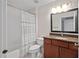 Bathroom features a vanity with granite countertop and shower with striped curtain at 602 Preston Village Way, Cary, NC 27519