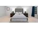 Well-lit bedroom with a tufted headboard, dual nightstands, and soft carpeting at 602 Preston Village Way, Cary, NC 27519