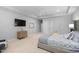 Bright, expansive bedroom with contemporary furniture, tray ceiling, and carpet flooring at 602 Preston Village Way, Cary, NC 27519