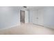 Bedroom with neutral carpet, trim, closet, and an open door at 602 Preston Village Way, Cary, NC 27519