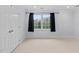 Bedroom with neutral carpet, trim and a window with black curtains at 602 Preston Village Way, Cary, NC 27519