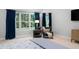 Comfortable bedroom showcasing an accent chair, side table, and large windows with blue drapes at 602 Preston Village Way, Cary, NC 27519