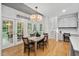 Formal dining room with french doors, chandelier, and views of the outside deck at 602 Preston Village Way, Cary, NC 27519
