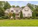 Charming two-story home with landscaped yard, painted brick, mature trees, and inviting curb appeal at 602 Preston Village Way, Cary, NC 27519
