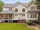 Rear exterior view of home with screened porch, deck and large arched windows at 602 Preston Village Way, Cary, NC 27519