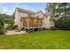 Rear exterior view of house featuring an outdoor screened in porch and well-manicured lawn at 602 Preston Village Way, Cary, NC 27519