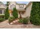 Stunning fountain with manicured landscaping leads to a welcoming porch on this lovely home at 602 Preston Village Way, Cary, NC 27519