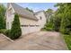 Side view of house featuring a spacious three-car garage and extended concrete driveway at 602 Preston Village Way, Cary, NC 27519