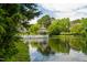 Charming gazebo sits on the lake offering a serene view of surrounding homes and mature landscaping at 602 Preston Village Way, Cary, NC 27519