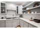 Bright kitchen features white subway tile backsplash and gray cabinets and countertops at 602 Preston Village Way, Cary, NC 27519