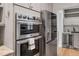 Modern kitchen features stainless steel oven and refrigerator, and granite countertops at 602 Preston Village Way, Cary, NC 27519
