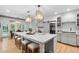 Gourmet kitchen with marble countertops, large island with seating, and stainless appliances at 602 Preston Village Way, Cary, NC 27519