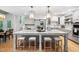 Eat-in kitchen features marble countertops, a large island with seating, custom cabinetry, and stainless appliances at 602 Preston Village Way, Cary, NC 27519