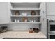Beautiful kitchen features stone countertops, tile backsplash, and built-in stainless appliances at 602 Preston Village Way, Cary, NC 27519