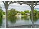 Captured view from the lakeside gazebo showcasing the tranquil lake, lush greenery, and beautiful homes at 602 Preston Village Way, Cary, NC 27519