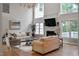 Bright and spacious living room with high ceilings, modern lighting, fireplace, hardwood flooring and neutral paint at 602 Preston Village Way, Cary, NC 27519