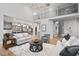 Large living room adjacent to open kitchen, hardwood flooring, high ceilings, and modern lighting at 602 Preston Village Way, Cary, NC 27519