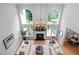 Open-concept living room with fireplace and oversized windows for natural light at 602 Preston Village Way, Cary, NC 27519