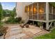 Charming patio with stone pavers and stairs leading up to the screened porch at 602 Preston Village Way, Cary, NC 27519