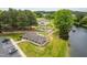 Community playground with swings and slides is surrounded by mature trees, walking paths, and a lake at 602 Preston Village Way, Cary, NC 27519