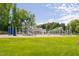 Vibrant community playground with climbing structures and play areas set against a backdrop of mature trees at 602 Preston Village Way, Cary, NC 27519
