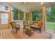 A view of the porch with wicker furniture, curtains, and a ceiling fan to provide a relaxing space at 602 Preston Village Way, Cary, NC 27519