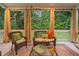 Inviting porch with wicker furniture and screened windows offering a scenic view at 602 Preston Village Way, Cary, NC 27519