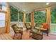 Relaxing screened-in porch with wicker furniture, overhead fan, and backyard views at 602 Preston Village Way, Cary, NC 27519