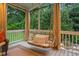 Relaxing screened porch with a cozy swing, perfect for enjoying the outdoor scenery at 602 Preston Village Way, Cary, NC 27519