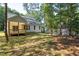 Picture of treed backyard with covered deck and house at 6069 Jones Cir, Sanford, NC 27332